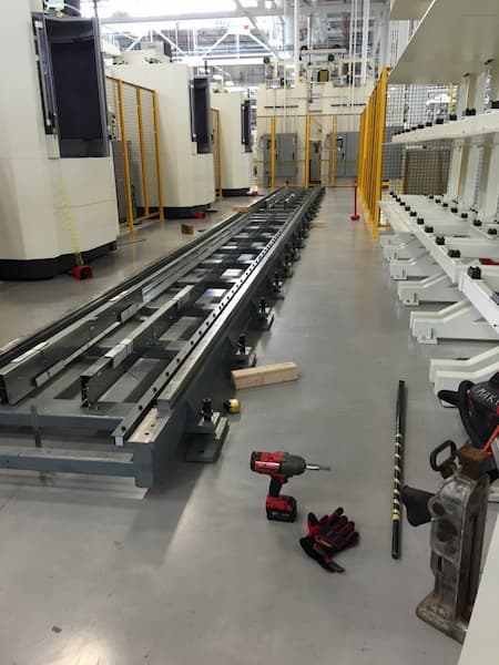 Floor mounted robot rail. Sections 1 and 2 being leveled and joined.